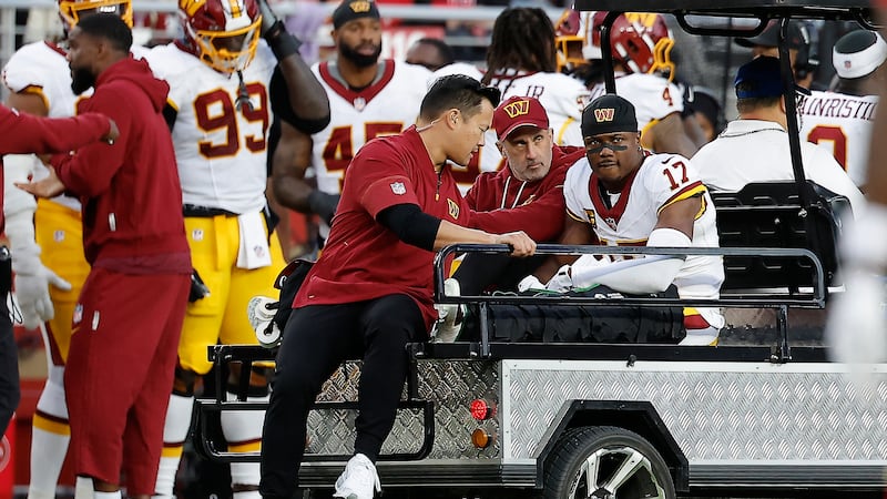 Washington Commanders wide receiver Terry McLaurin (17) is carted off the field during the...