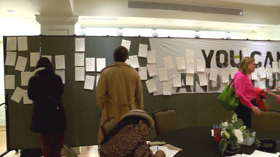 People leaving messages on boards for the Celebration of Life for Bill Martin at Valentine...