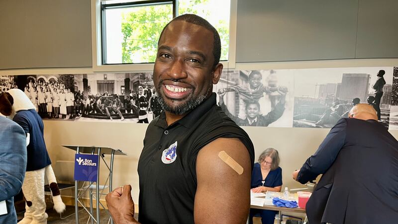 Richmond Mayor Levar Stoney does a flu shot flex, part of a state and local push to encourage...
