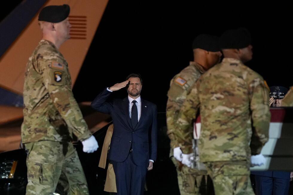 Vice President JD Vance salutes as an U.S. Army carry team moves the transfer case containing...