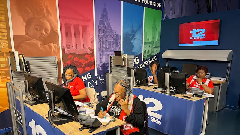 Red Cross volunteers answer Call 12 phones to help collect donations for Hurricane Helene relief.