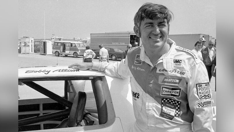 FILE - Bobby Allison stands beside his car and talks with the press after winning the pole...