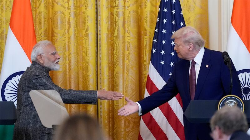 President Donald Trump and India's Prime Minister Narendra Modi shake hands during a news...