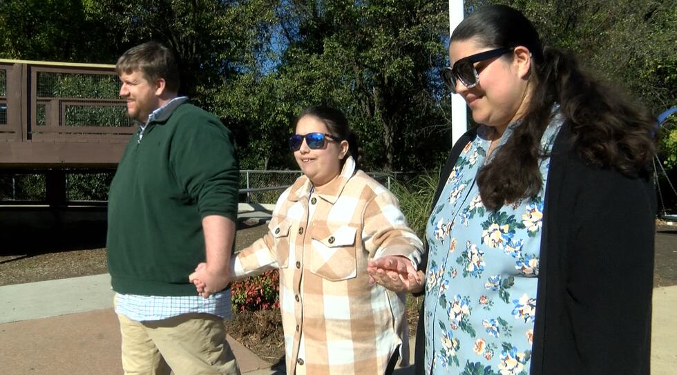 9-year-old Abby Alvey walks with her parents, Garland and Melissa.