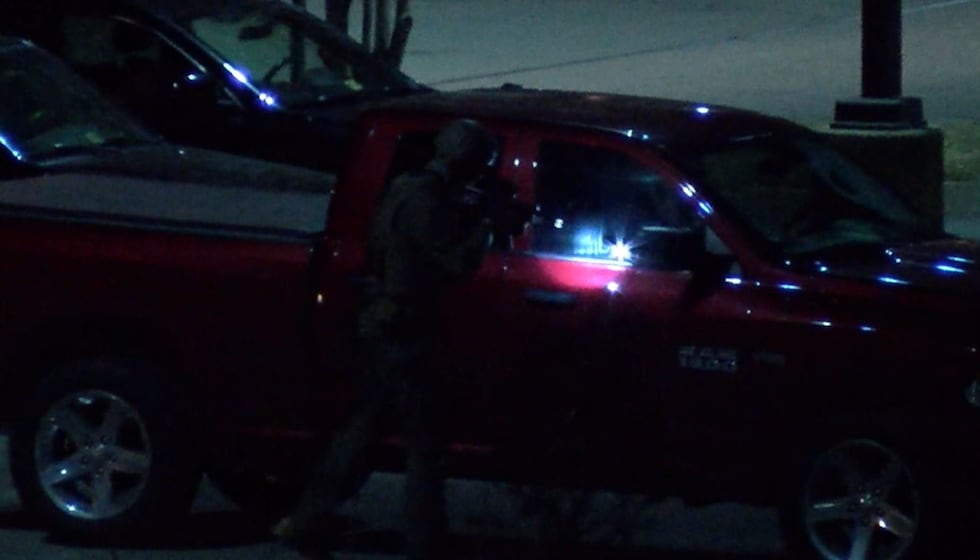 A police officer investigates a vehicle. (Source: NBC12)